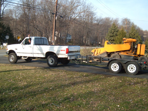 Mr. Stump truck and grinder parked in a driveway, ready for same-day service