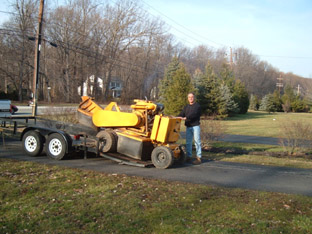 Mr. Stump's self-propelled stump grinder at work in a residential yard